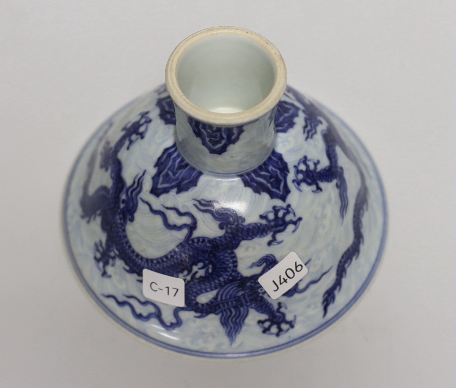 A Chinese blue and white porcelain stem bowl decorated with dragons, housed in a fitted case, 10cm high